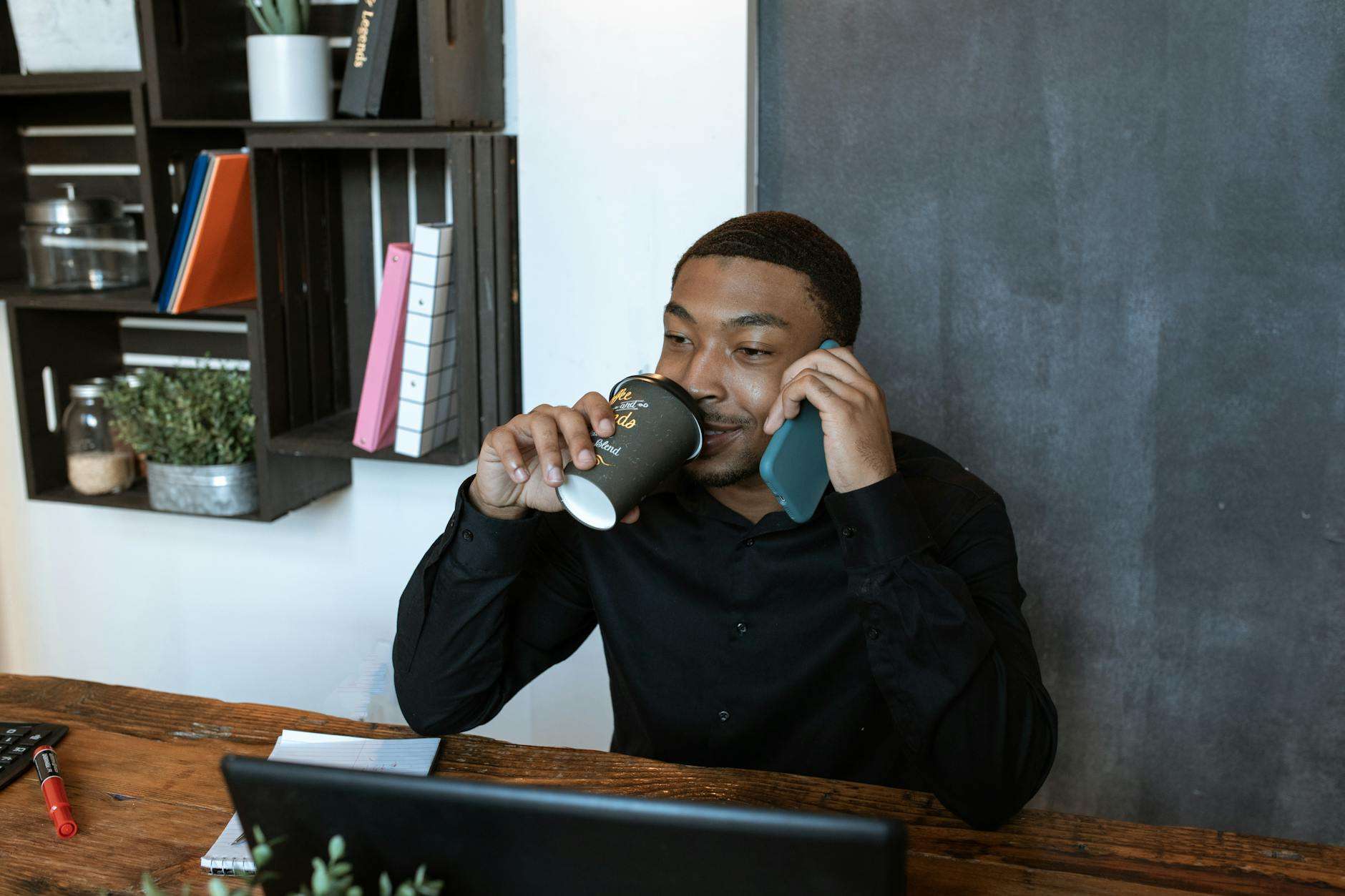 man in black jacket drinking from gray ceramic mug