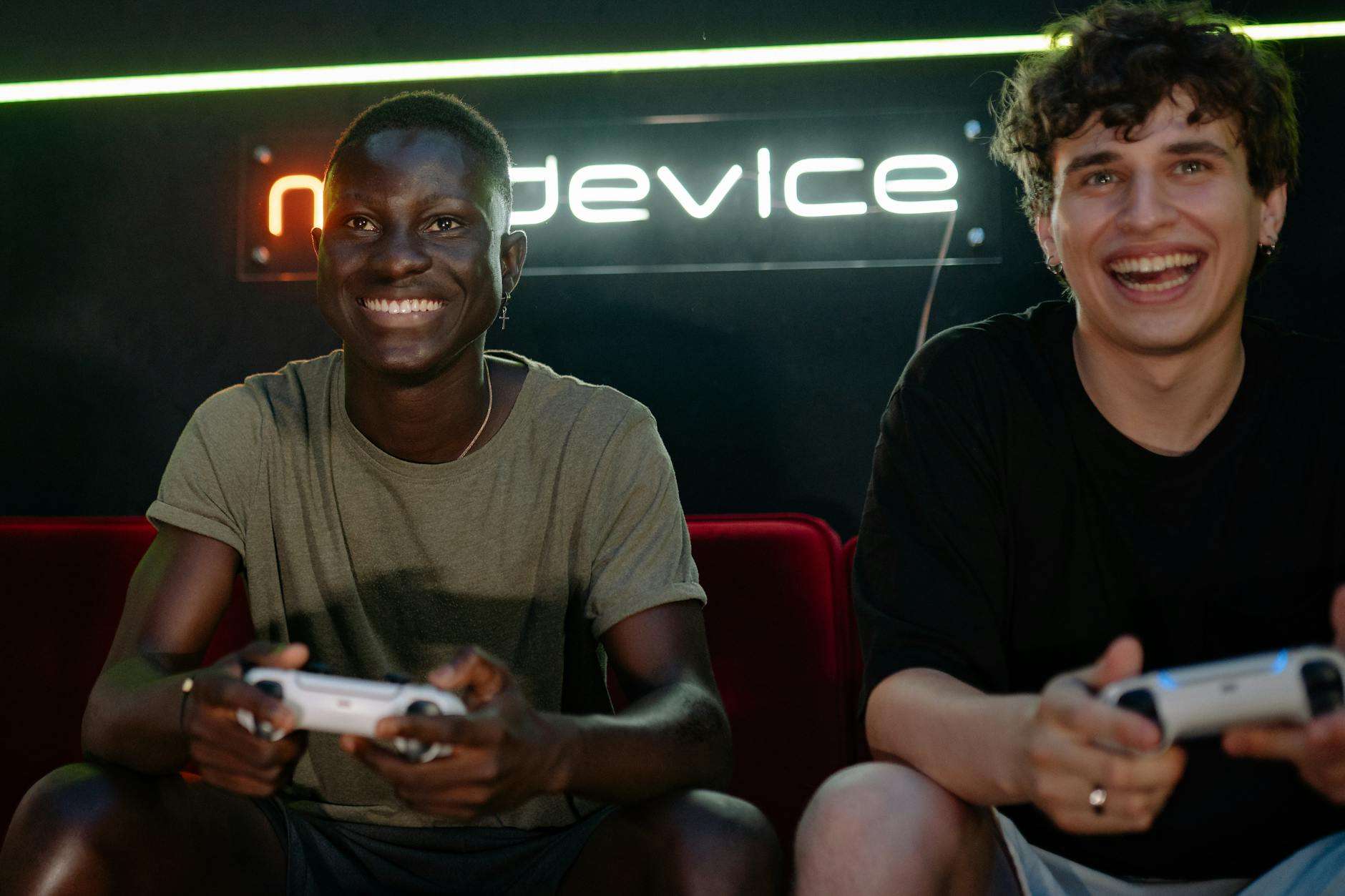 two men playing video games while sitting